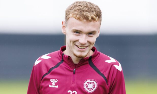 Adam Forrester smiles during a Hearts training session.