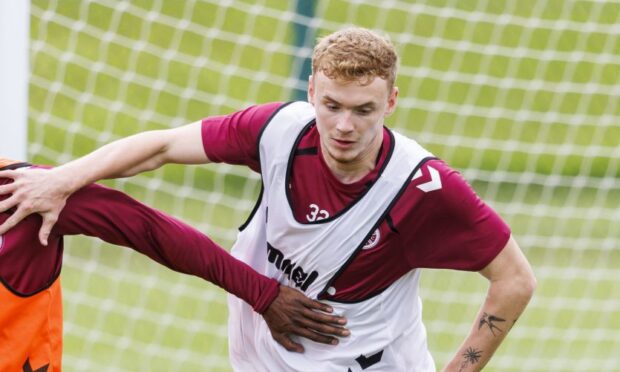 Adam Forrester battles for the ball in a Hearts training session.