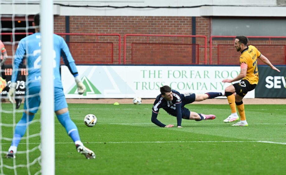 Dundee sub Charlie Reilly goes down under Danny Wilson's challenge to win Dundee the penalty to win the game. Image: Rob Casey/SNS