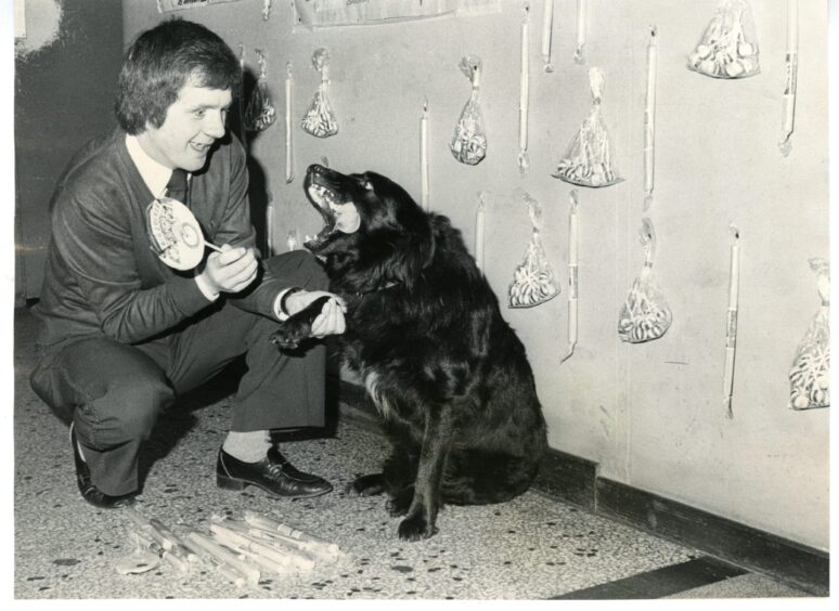 Jimmy Smith, manager of the Rialto Bingo Club, Lochee, with Ri, the Club's dog, in September 1983.
