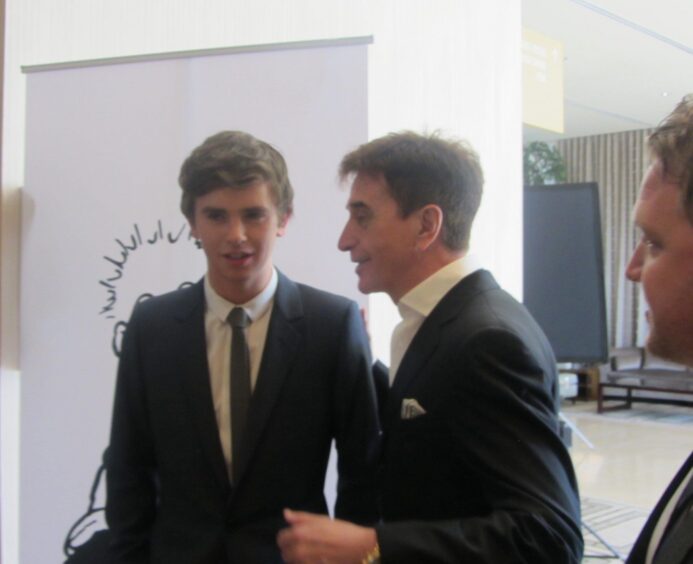 Actor Freddie Highmore, star of The Assassin and Bates Motel, with Tony Cochrane and the pop-up Oor Wullie banner.