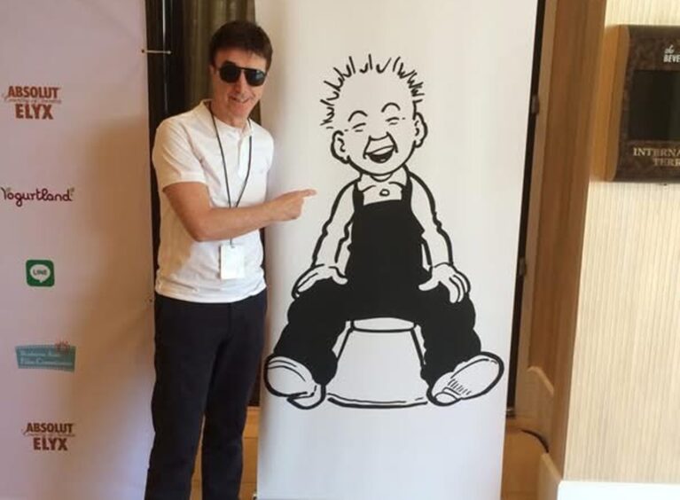 Tony Cochrane with his pop-up Oor Wullie banner.