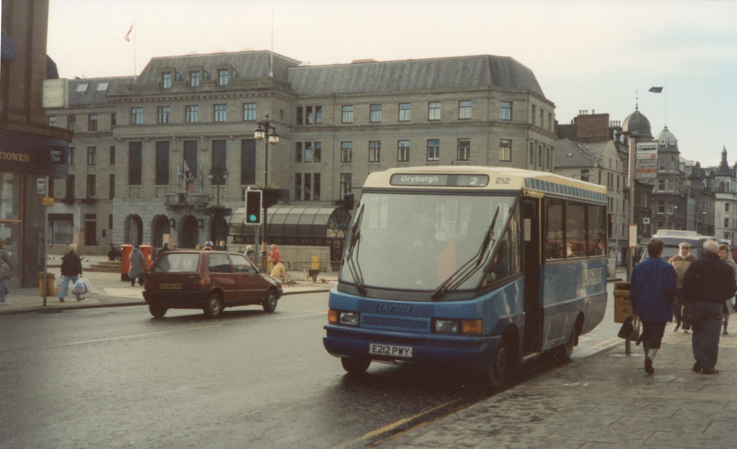 A minibus passes Dundee City Square.