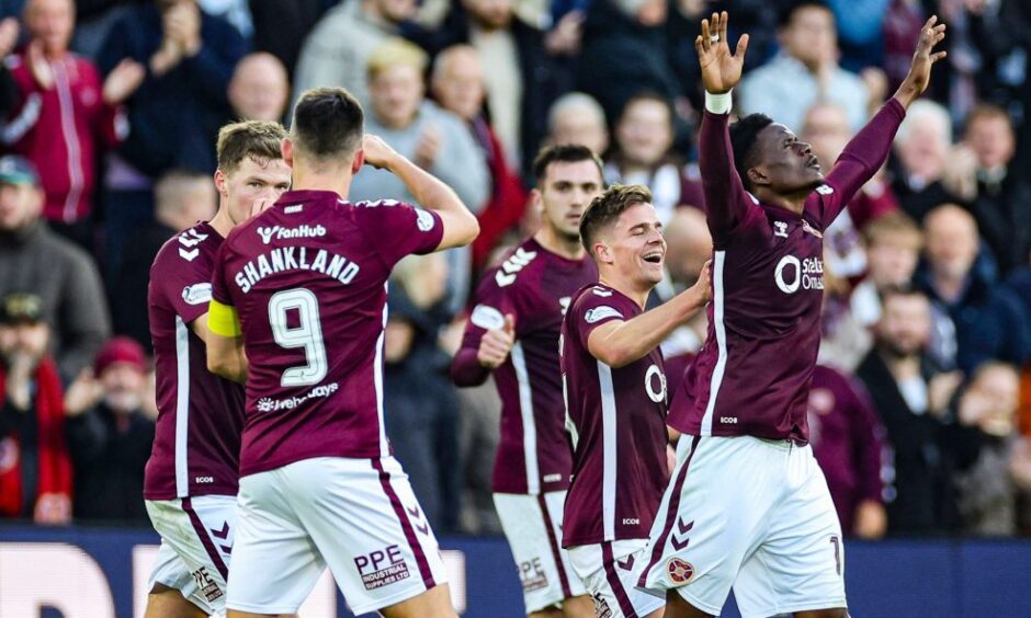 Landry Kabore and his Hearts teammates celebrate.