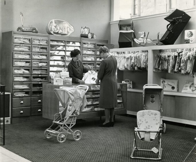 Inside the Alex Smith store on the Hilltown shop in 1969 with a woman helping customers.