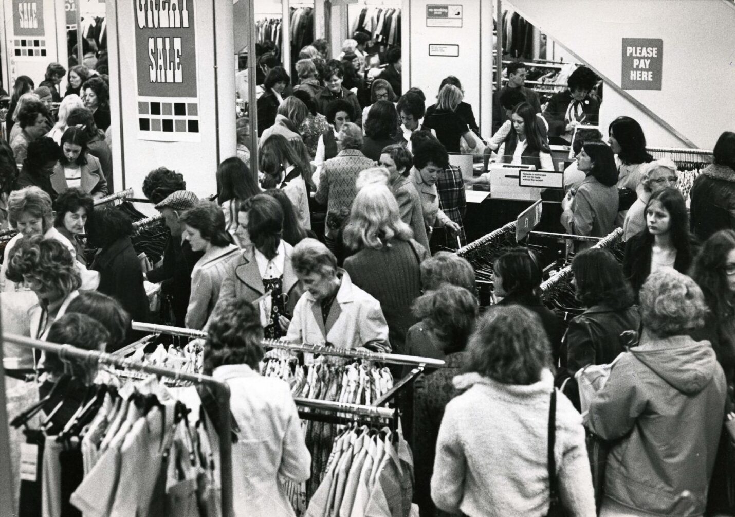 People check out a clothing rail.