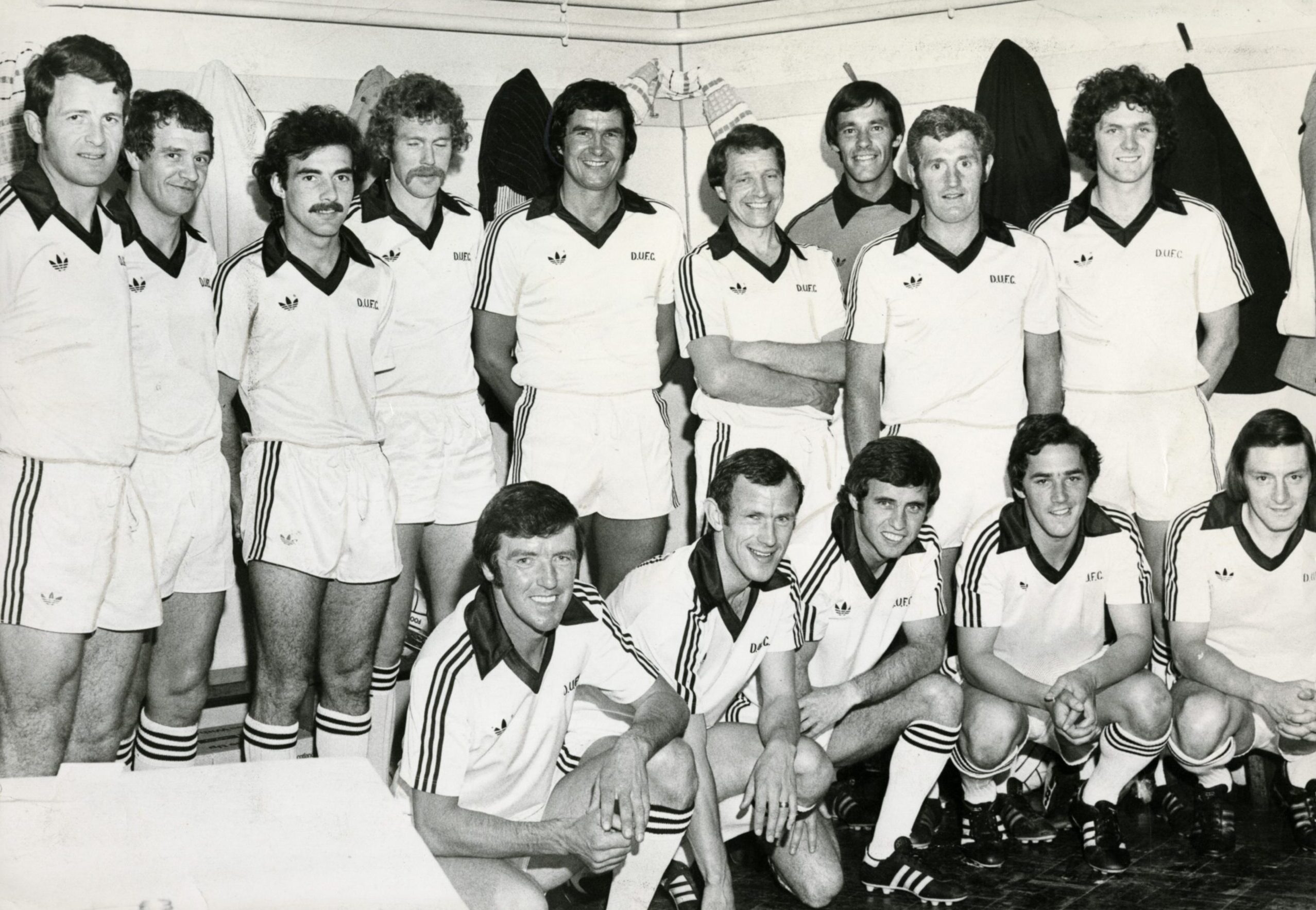 Doug Smith in the dressing room with team-mates before his testimonial match. The players are wearing all white Adidas strips.