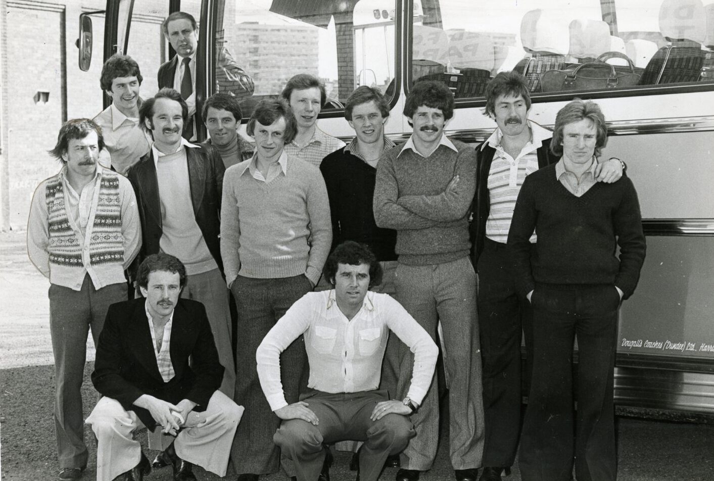 Players stand in front of a bus before heading to the airport from Tannadice for a competition in Japan. Boss Jim McLean is standing on the bus step.