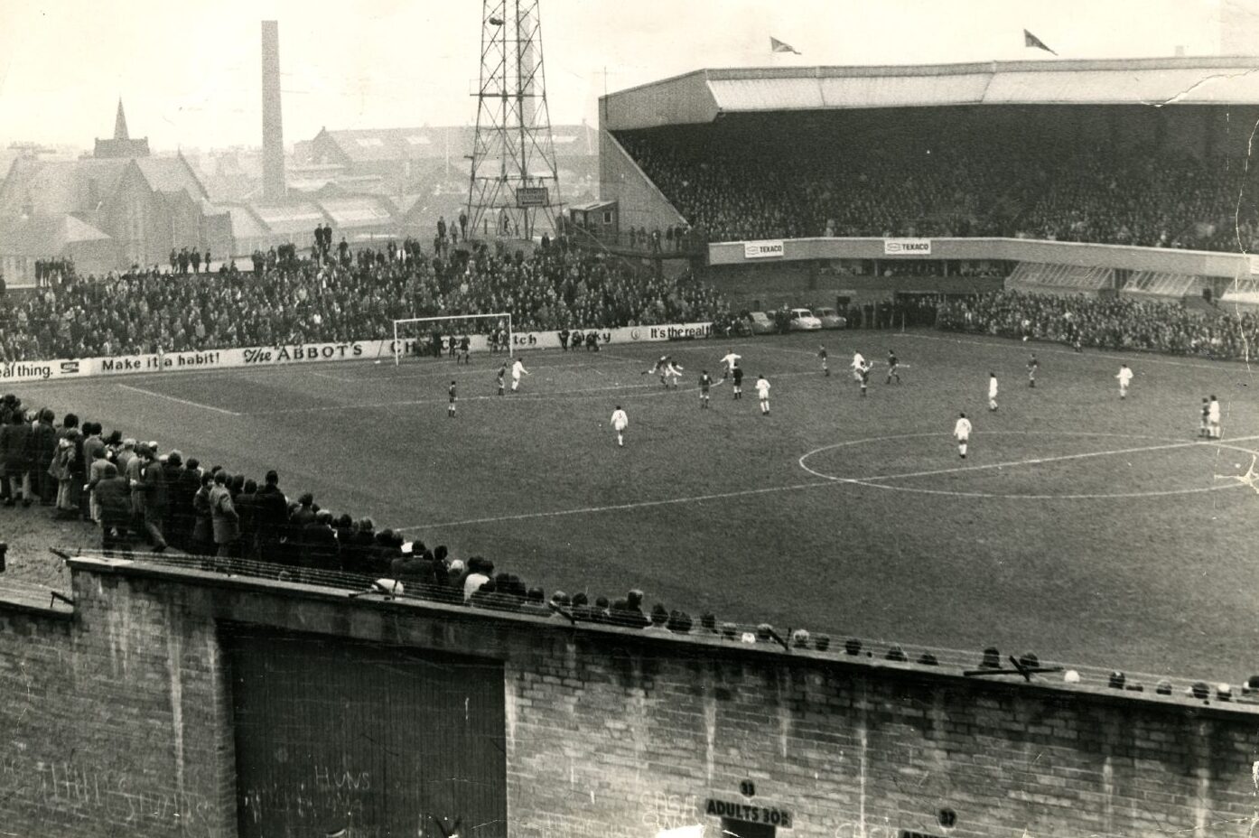 A shot from on high of a Scottish Cup tie between Dundee United and Aberdeen at Tannadice in 1972. There is a large crowd watching the action from the open terracing and main grandstand.