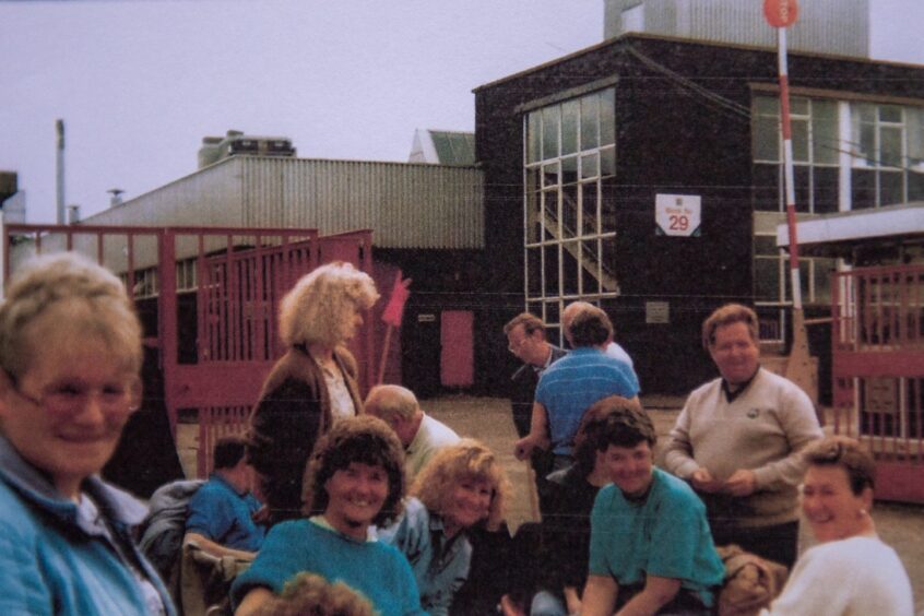 People stand at the factory gate during the Albacom strike in Dundee.