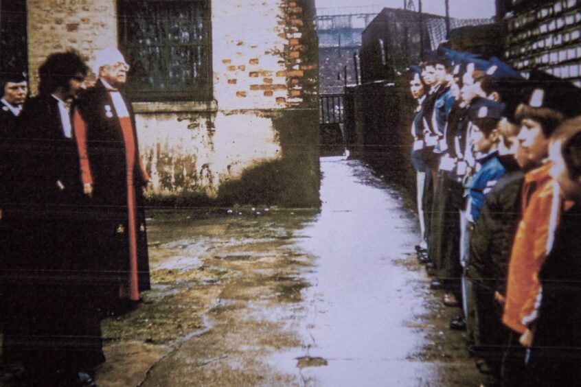 A young Erik Cramb with a fellow minister and some Boys' Brigade youngsters.