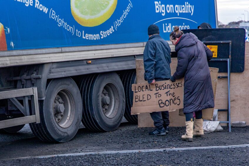 A lorry mounts the kerb as it negotiates a corner