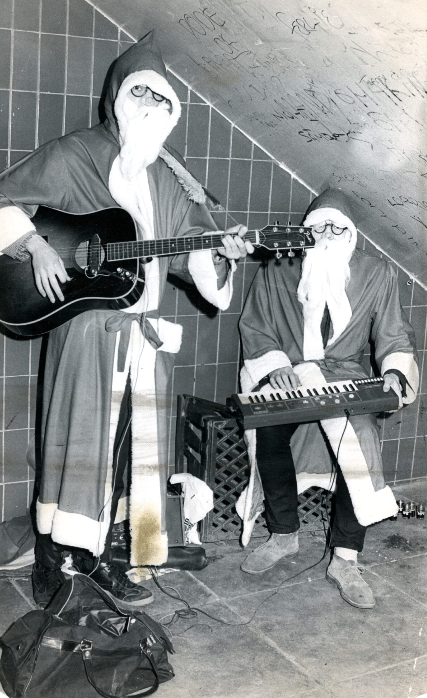 Two people busking dressed as Santa.