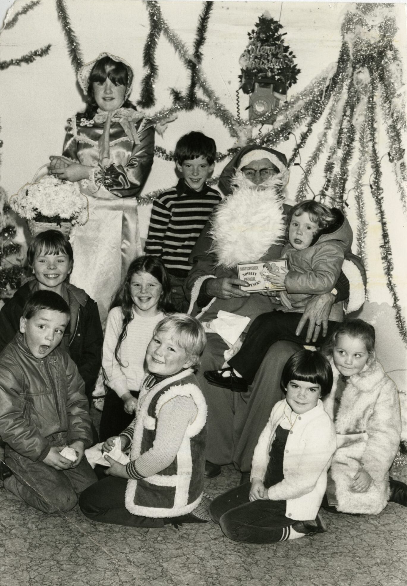 Santa hands over presents in a grotto.