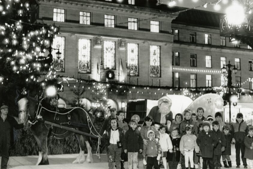 Santa and children beside the Dundee Christmas lights. 