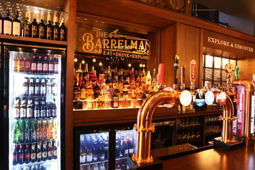 drinks and fridges behind the bar in Dundee pub The Barrelman 