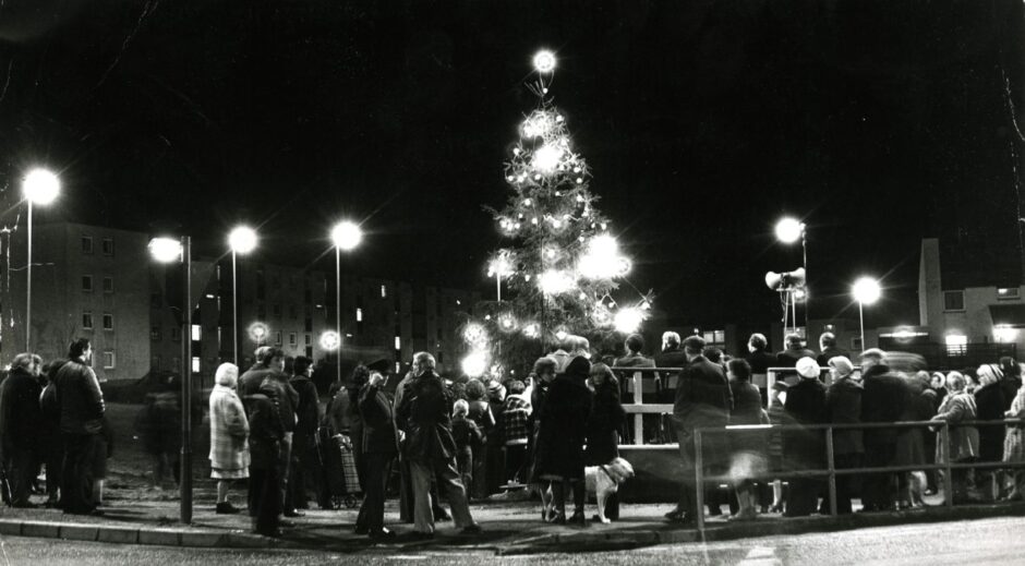 A large Christmas tree lit up at night in Lochee, Dundee