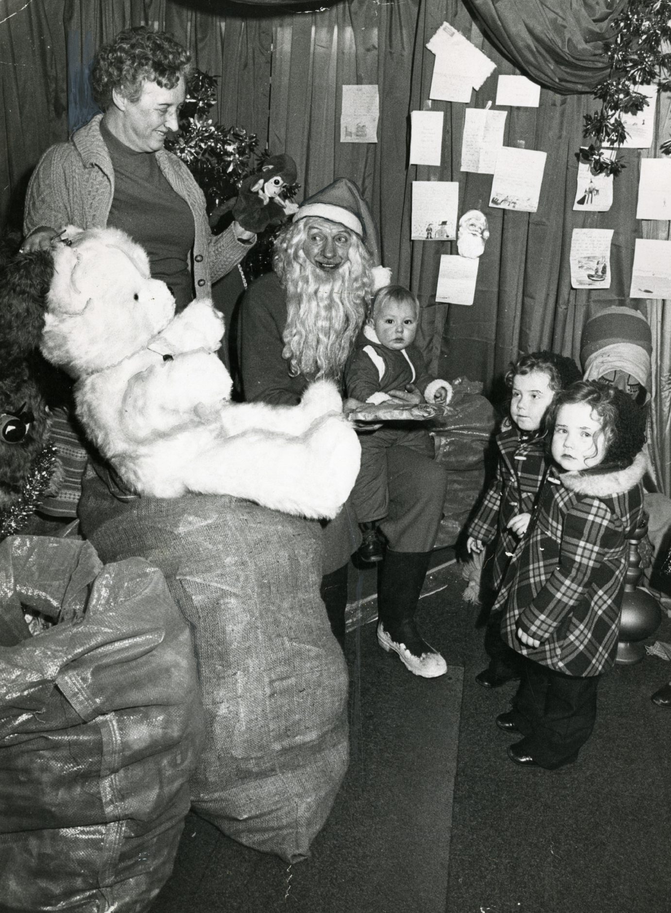 Santa with kids at a grotto.