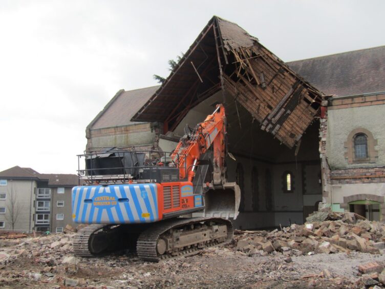 A bulldozer gets to work tearing down Craigiebank Church in Dundee