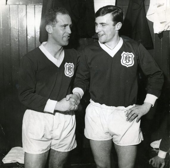 Sammy Wilson and Bobby Wilson shake hands in the dressing room. 