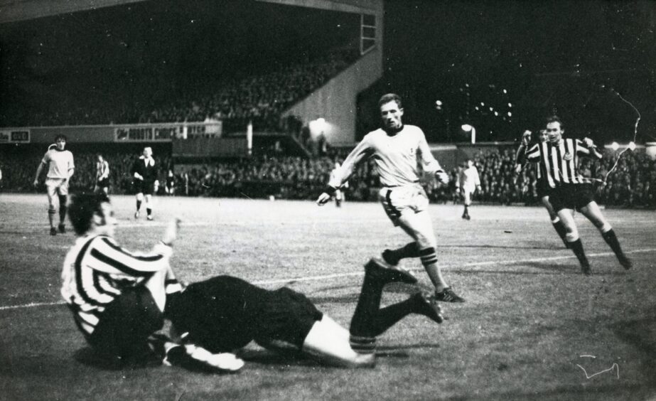 players collide during the Dundee United versus Newcastle game