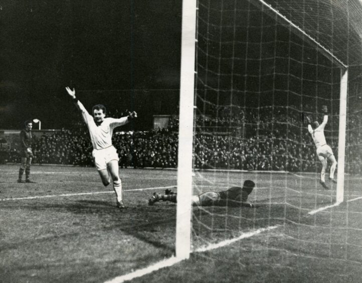 two Dundee United players celebrate in the box after a goal against Barcelona