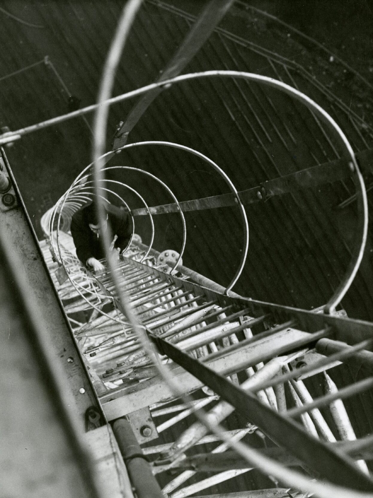 an elevated shot showing an electrician examining the floodlights in January 1960. 