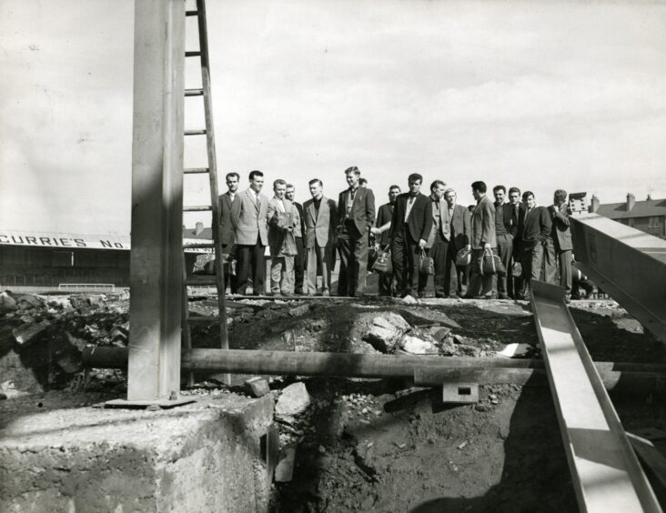Players surrounded by scaffolding at Tannadice.