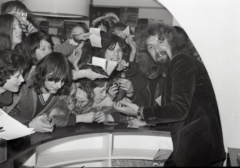 A smiling Billy Connolly with fans in Dundee.