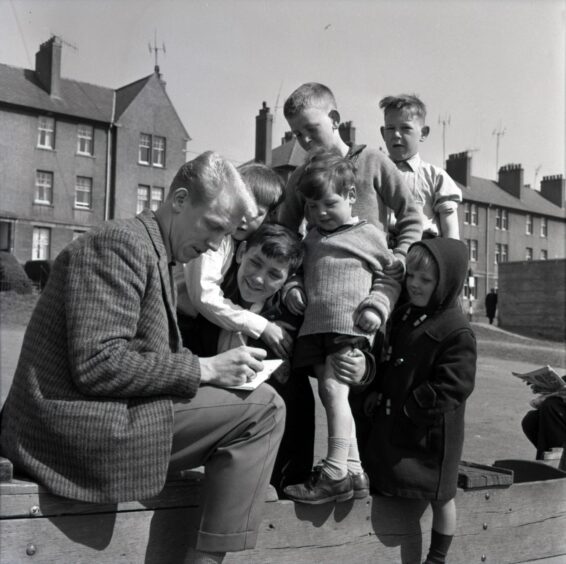 Ian Ure signs autographs for a group of kids at Dens in April 1962.