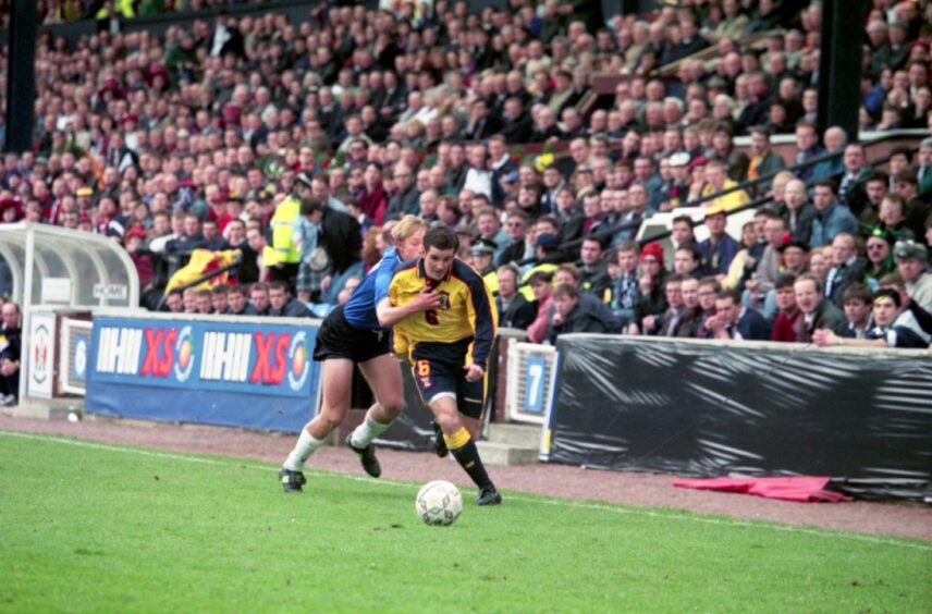 McKinlay runs down the wing while for Scotland against Estonia in March 1997.
