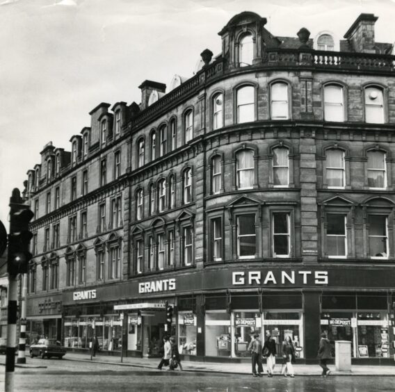 people walk by the outside of Grant's