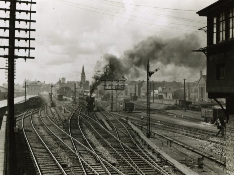 A train passes with lots of steam in Dundee.