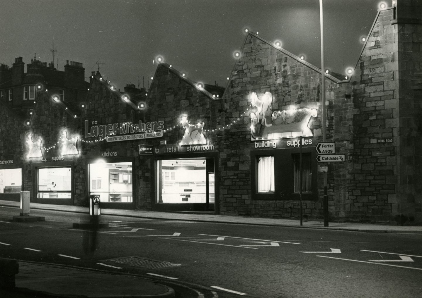 A showroom with Christmas lights on the roof.