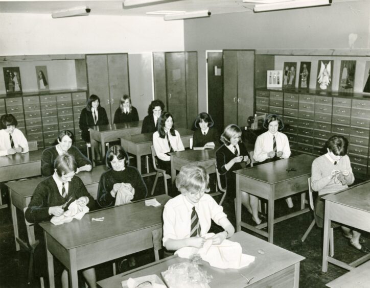 Lawside Academy pupils at their desks sewing.