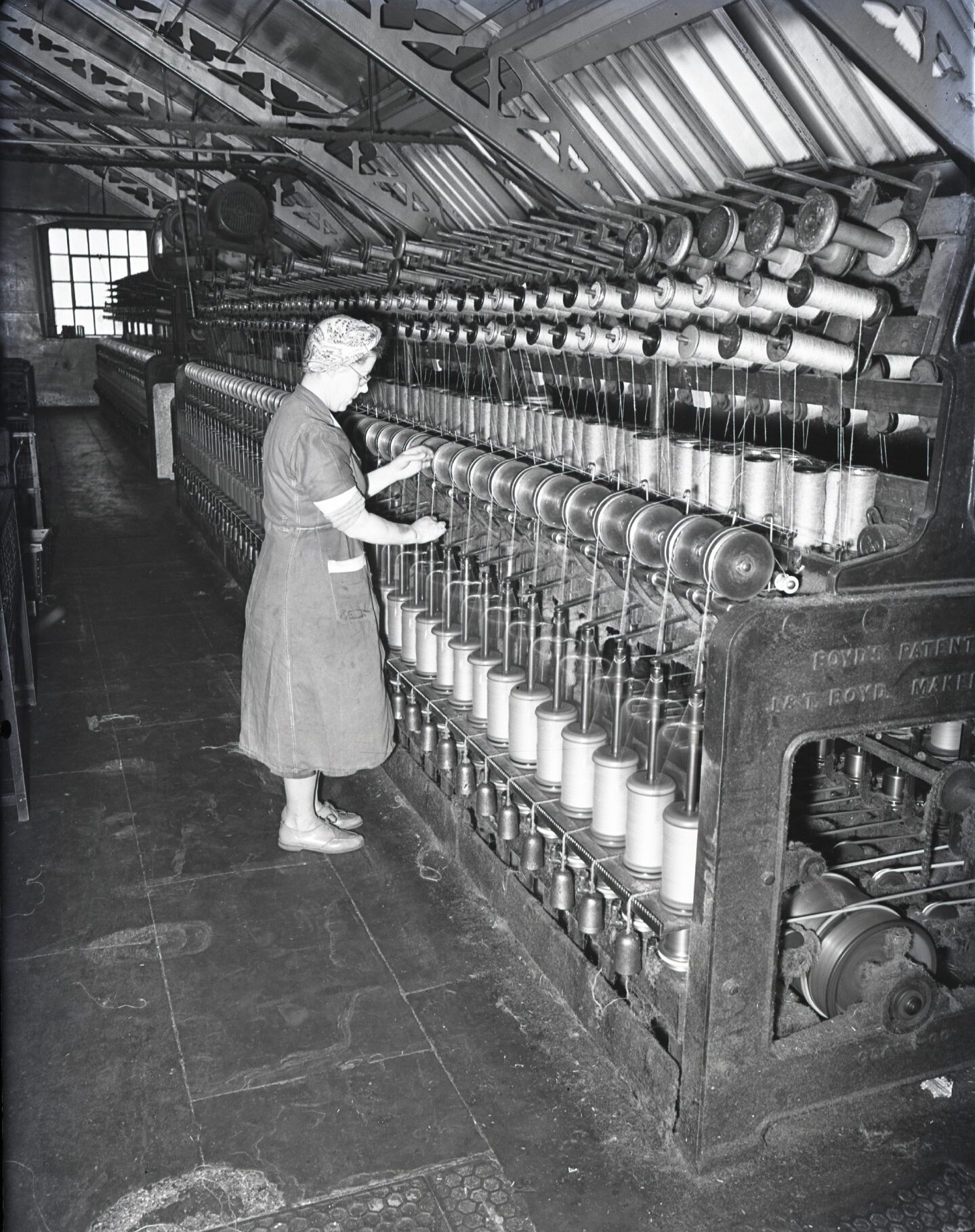 A woman working on a mill floor in a jute mill.