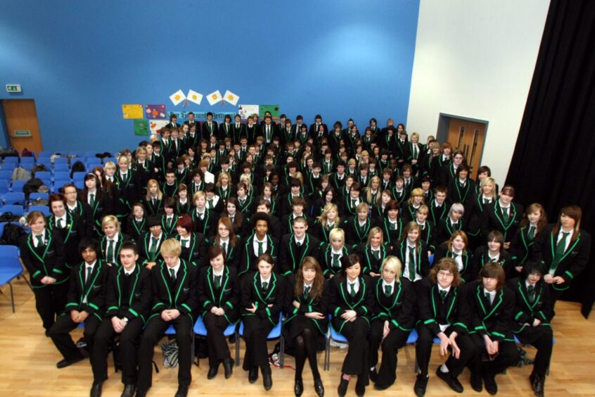 Senior pupils seated in a hall at the new school in 2009.