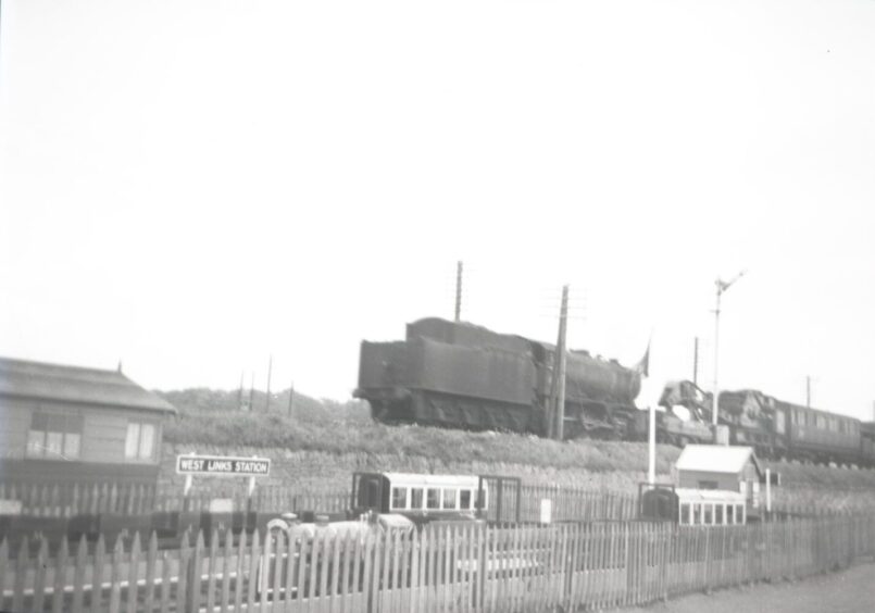 A train passes a miniature railway.