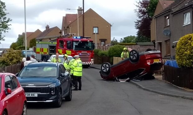 Firefighters at Auchterarder crash after car ends up on its roof