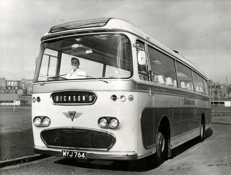 A driver behind the wheel of the new single-decker bus. 
