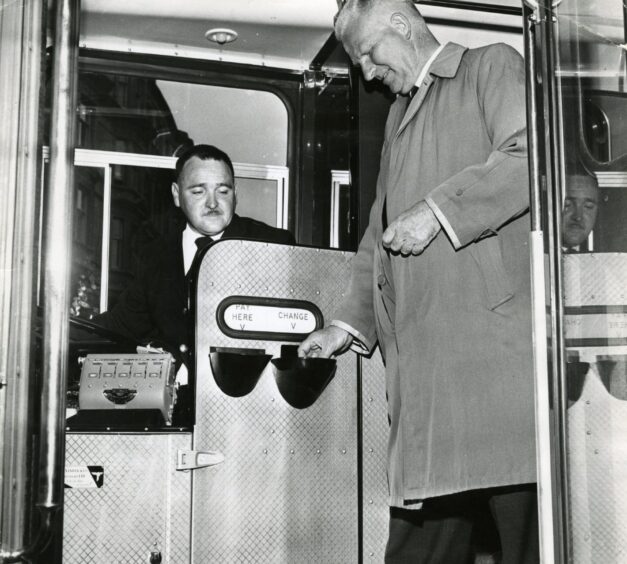 a driver takes a passenger's fare.