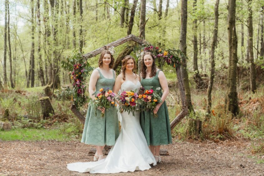 Bride with her bridesmaids. Bride in white and bridesmaids are wearing green.