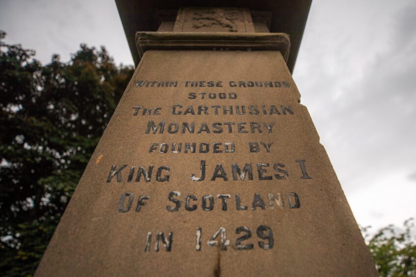 Stone pillar which reads 'within these grounds stood the Carthusian Monastery founded by King James I of Scotland in 1429'