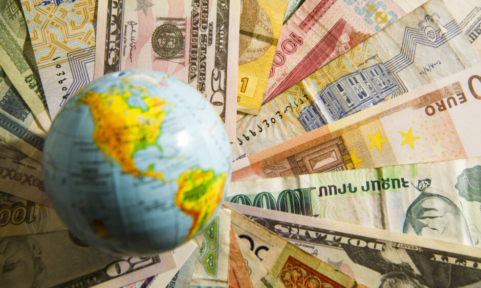 Globe over bills representing debt for climate swaps.