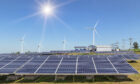 Renewables: solar panels and wind turbines.