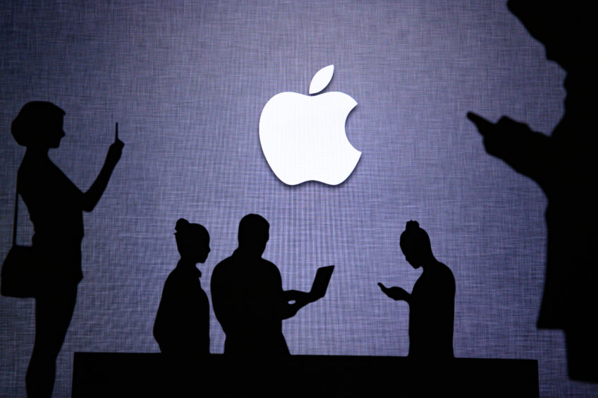 An apple logo with silhouettes of people on their phones