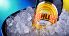 A bottle of Kahlúa sitting in an ice bucket.