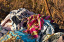 A heap of discarded clothing.
