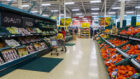 Shoppers browse the aisles of a Tesco supermarket.