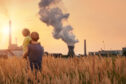 Children stand looking at power station.